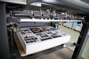 Machine Printing Papers at Printing Company in Brooklyn, NY