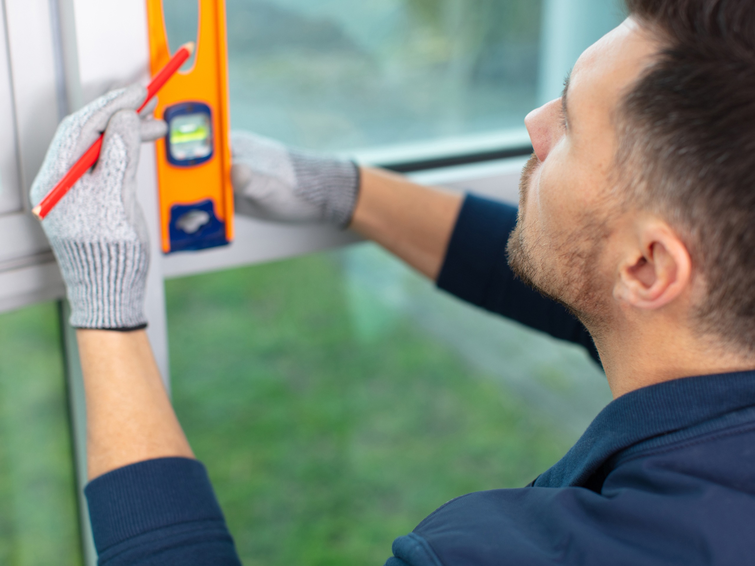 worker measuring for Storefront Window Tinting, Commercial Window Graphics, and Custom Office Window Films in Essex County, MA