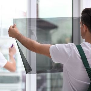 A Contractor Performing a Commercial Window Film Installation in Boston, MA